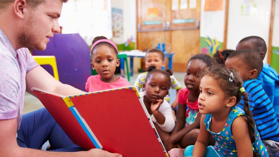 A man with pre-school children