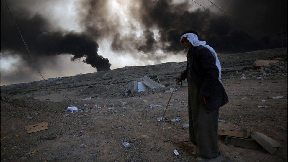 A man flees the fighting near Mosul in northern Iraq, 22 October, 2016