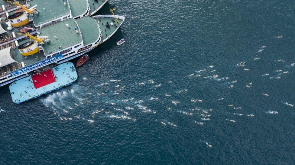 An aerial photo shows the moment swimmers begin the race