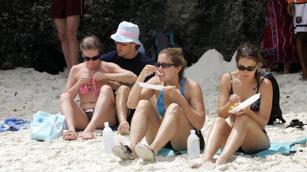 Tourists enjoy their lunch at Maya Beach