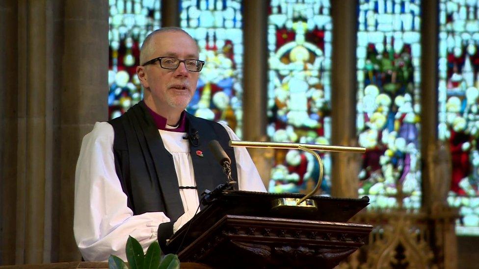 Bishop Jonathan Clarke reads the names of the victims of Wednesday's tram crash