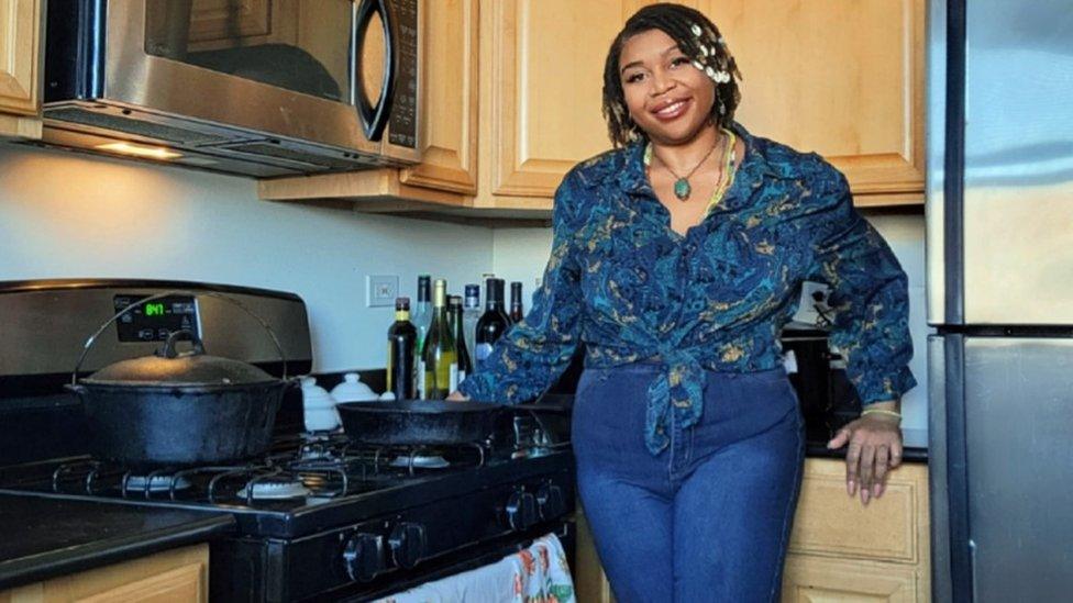 Jatohn Redeaux with her great-grandmother's cooking pot and skillet