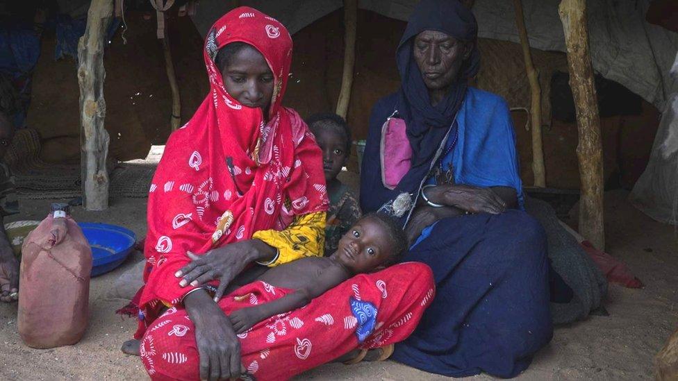 Fatima (R) and her daughter (L) who has one of her children cradled in her lap