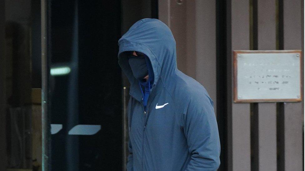 Curtis Warren, with his face covered, leaving Liverpool Crown Court