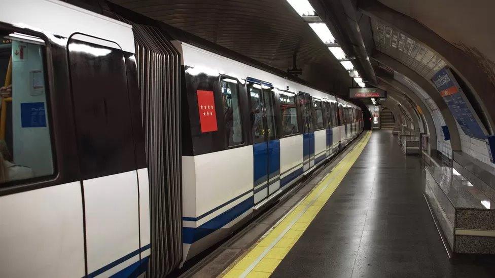 A stock image of an underground train at a station platform