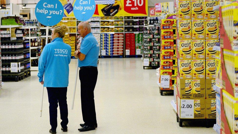 Two staff-members in a Tesco store