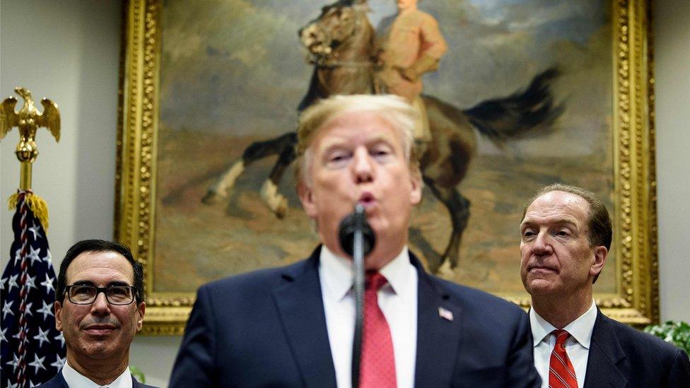 US Secretary of the Treasury Steven Mnuchin (L) listens while US President Donald Trump (C) announces David Malpass"s (R) candidacy to lead the World Bank during an event in the Roosevelt Room of the White House February 6, 2019