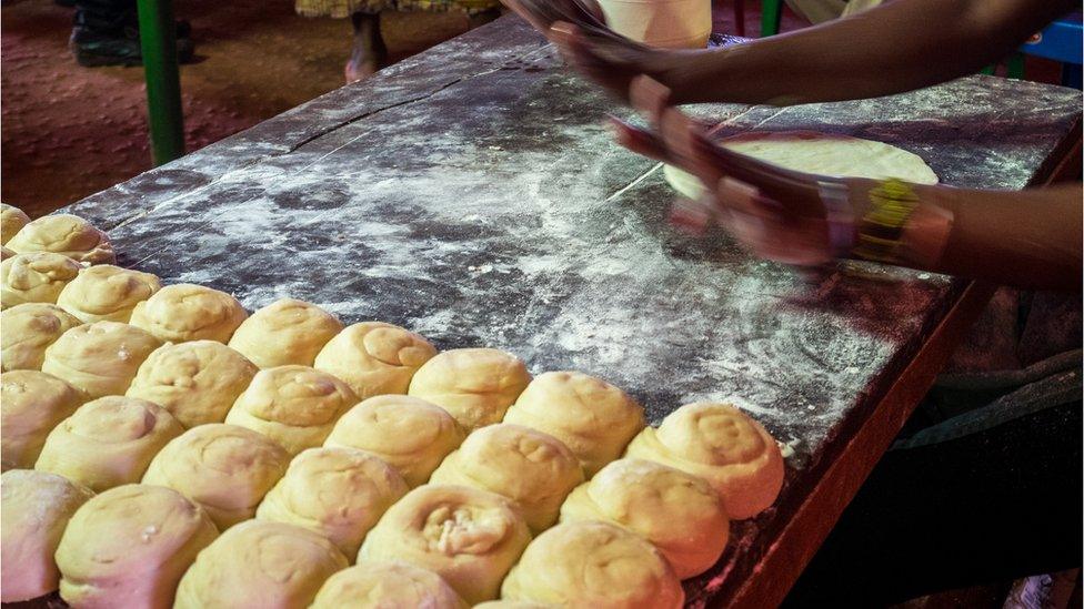 Preparing chapati in a simple restaurant in Kenya, East Africa