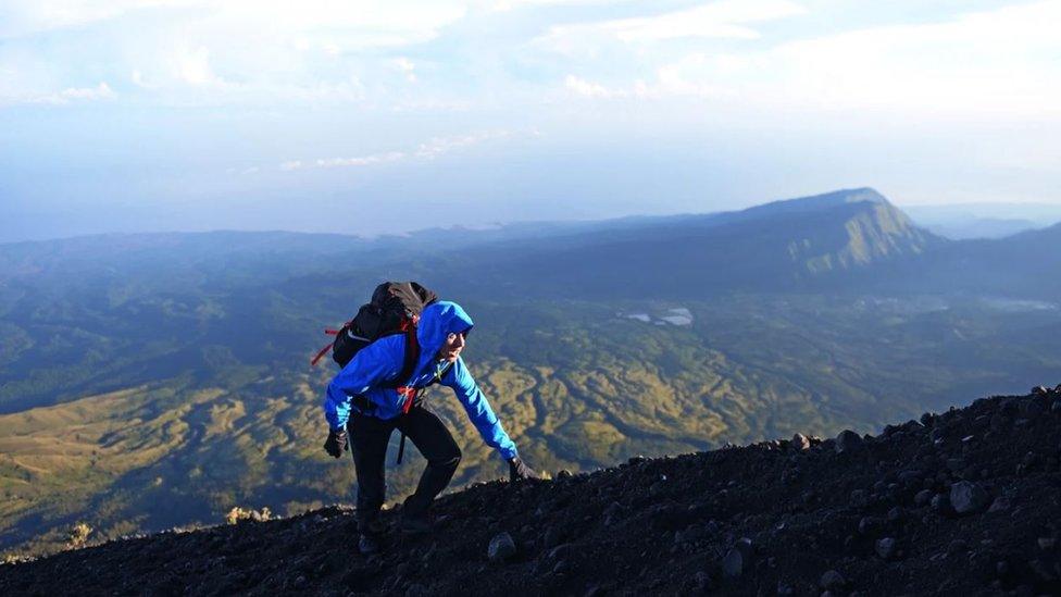 Ash Dykes climbing a mountain