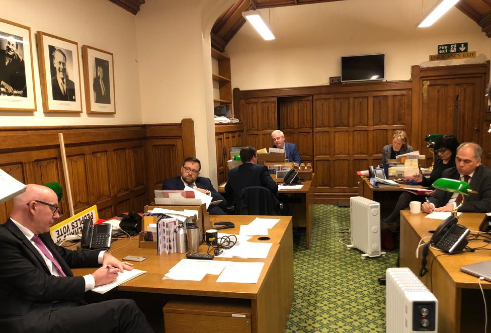 Mark Tami (rear) sitting in the Labour Whips office in the House of Commons