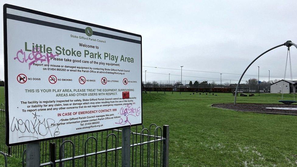 A sign saying welcome to Little Stoke Park with play equipment in the background