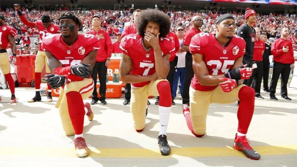 Colin Kaepernick (C), Eli Harold (L), and Eric Reid (R) taking the knee during in 2016.