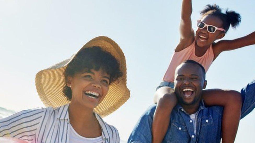 Family-cheering-on-beach.