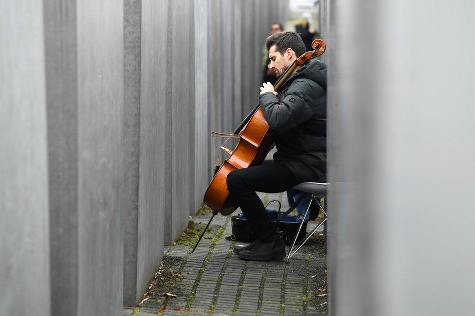 Slovenian cello Luka Sulic plays as part of a service