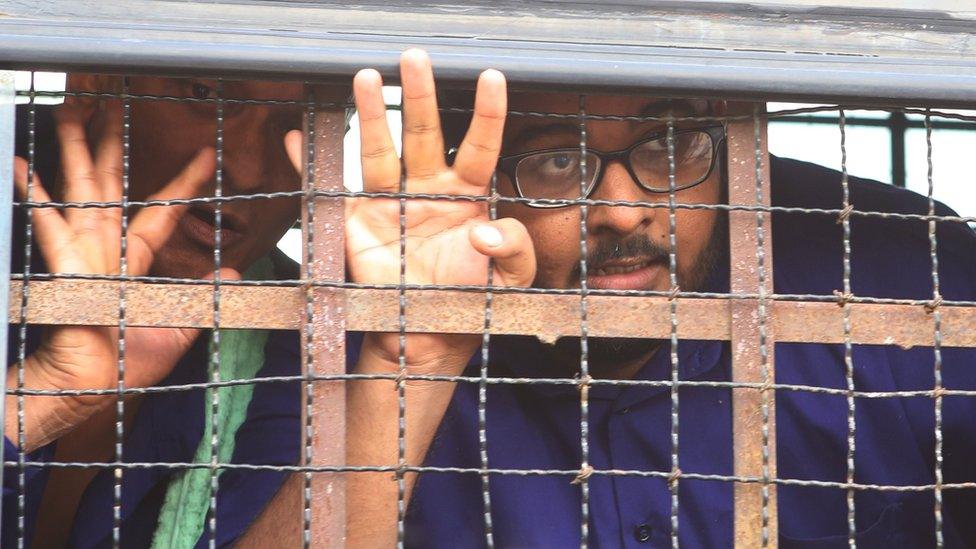 Myanmar freelance journalist Aung Naing Soe (R) arrives in a prison van for a hearing on his trial at Zabu Thiri Court in Naypyitaw, Myanmar, 27 November 2017.