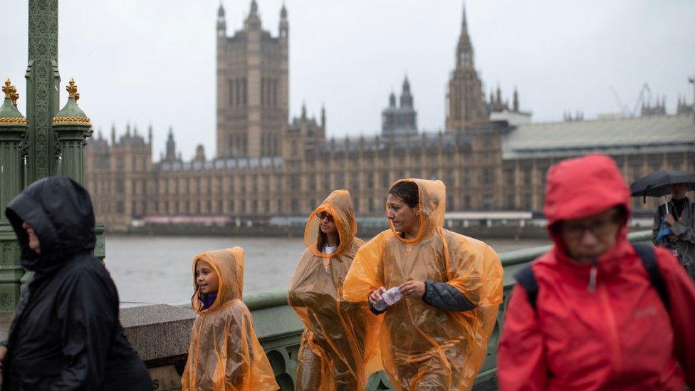 family-in-rain-ponchos-in-London.