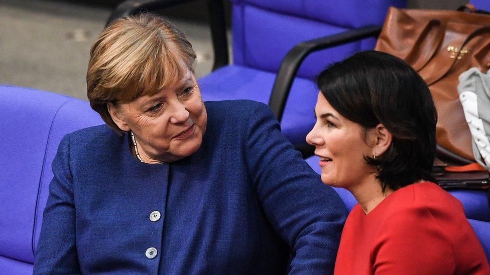 German Chancellor Angela Merkel (L) talks with German Green Party Co-Chairwoman Annalena Baerbock (R) in January 2020