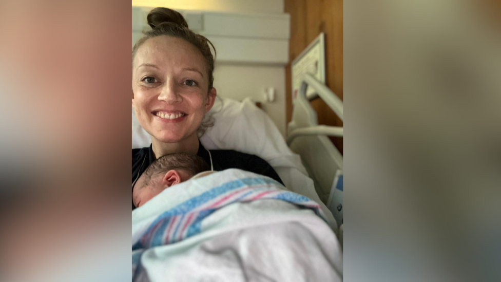 Holly Cairns, leader of Ireland's opposition Social Democrats party, poses with her new born daughter in hospital.