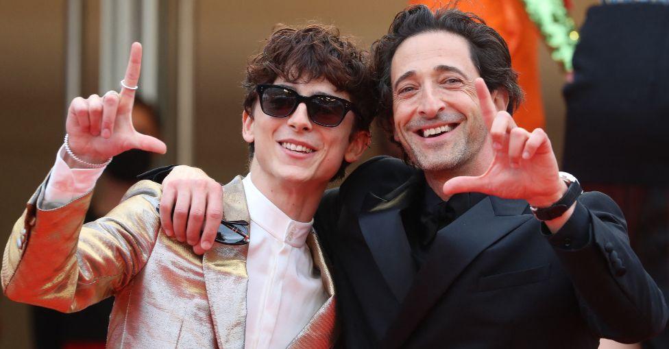 French-Us actor Timothee Chalamet (L) US actor Adrien Brody pose as they arrive for the screening of the film "The French Dispatch" at the 74th edition of the Cannes Film Festival in Cannes, southern France, on July 12, 2021