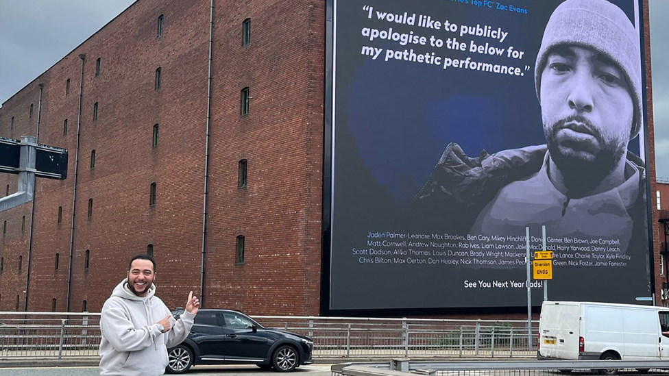 Zac Evans in front of the billboard