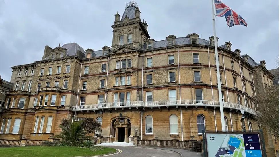 A general view of Bournemouth Town Hall, a Victorian era building with five floors and the Union Flag flying outside.