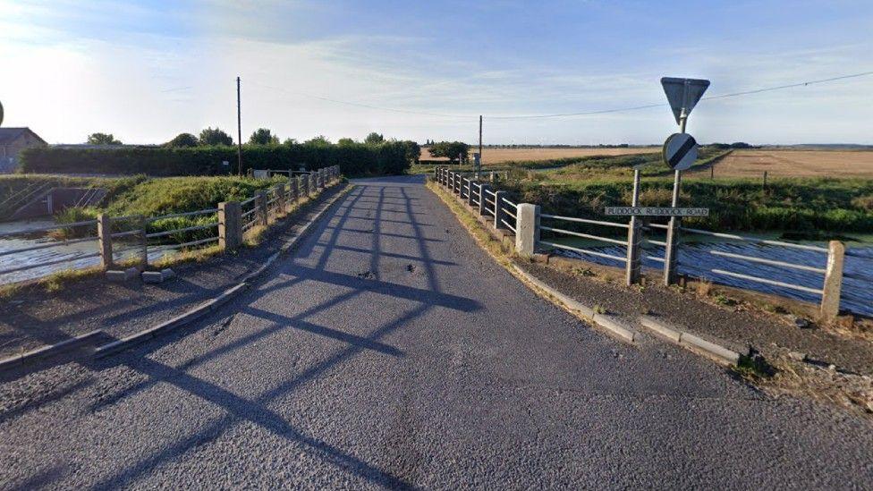 Puddock Road showing a bridge and road sign