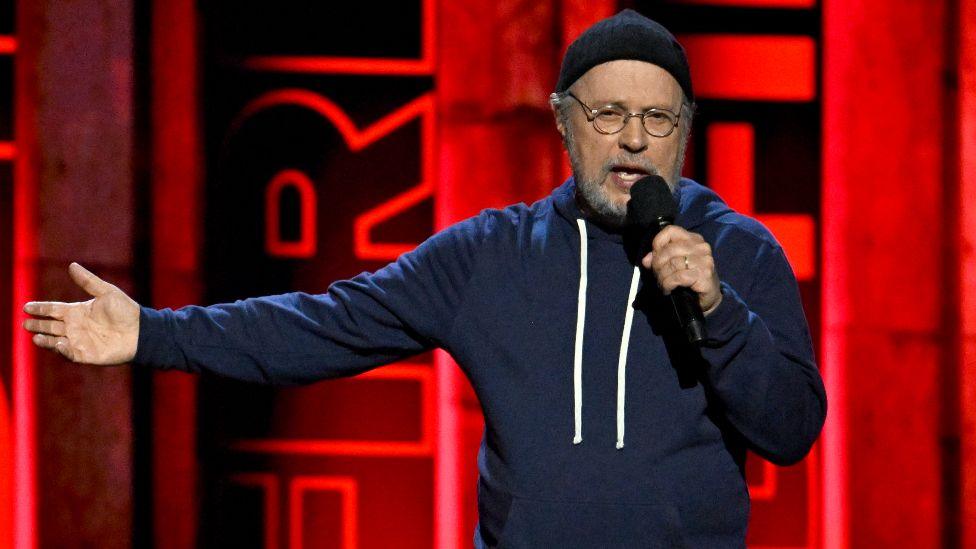 Billy Crystal speaks onstage during the FIREAID Benefit Concert for California Fire Relief at The Kia Forum on January 30, 2025 in Inglewood, California