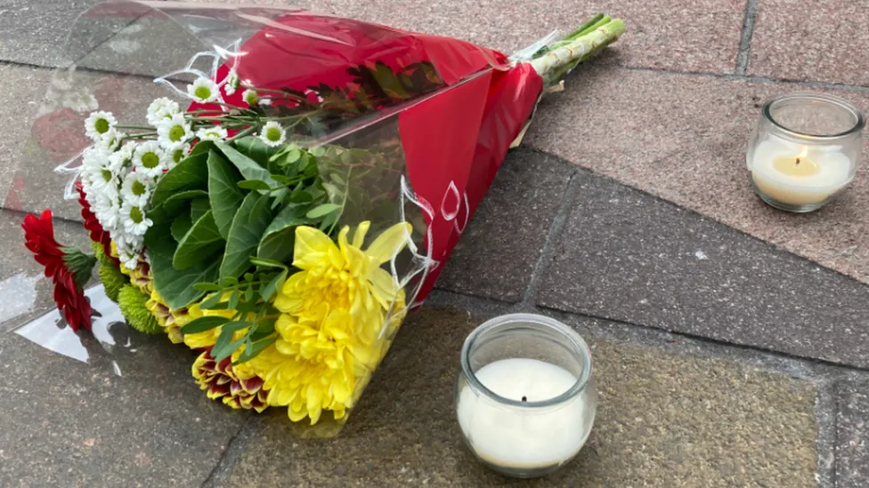 Flowers and candles at a vigil