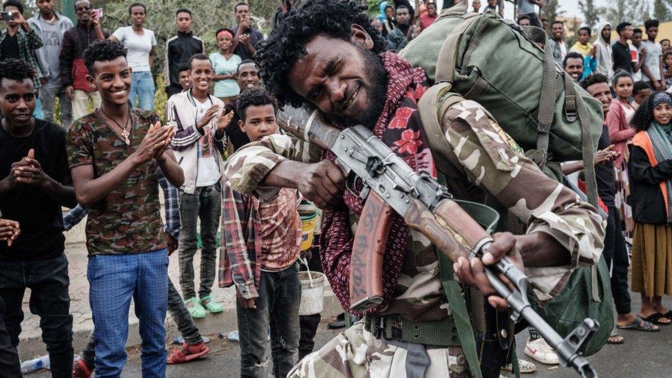 A soldier of Tigray Defence Force (TDF) poses as he walks towards another field at Tigray Martyr's Memorial Monument Center in Mekele, the capital of Tigray region, Ethiopia, on June 30, 2021