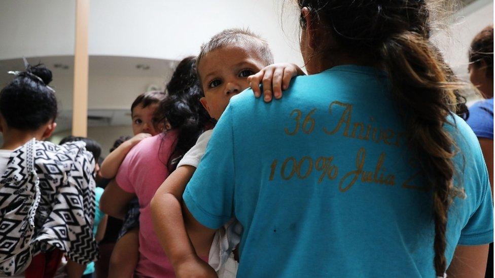 Migrant mother holding child