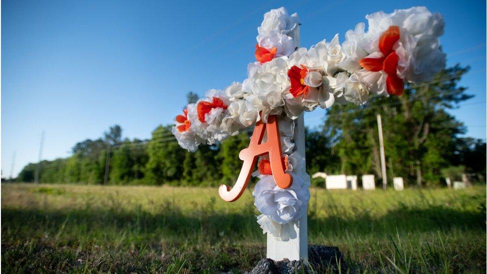 A cross for Ahmaud Arbery outside the neighbourhood he was shot in