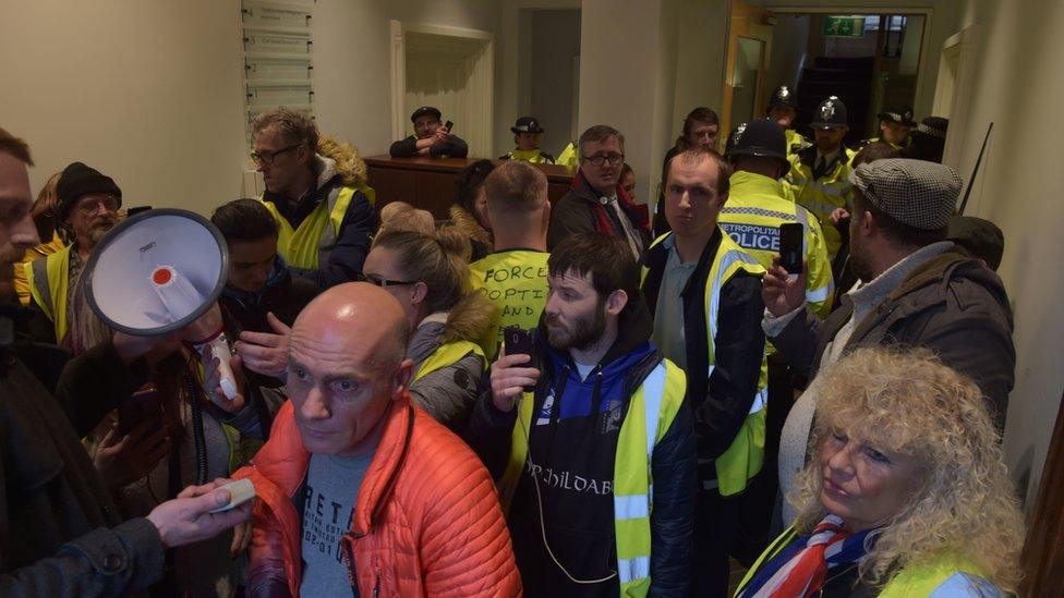 Protesters inside the attorney general's office building