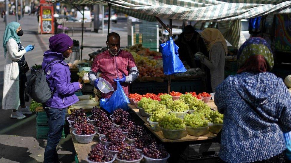 People at market stall in London