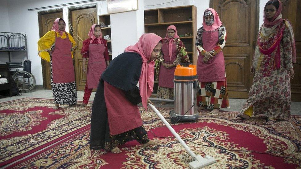 Woman vacuuming carpet