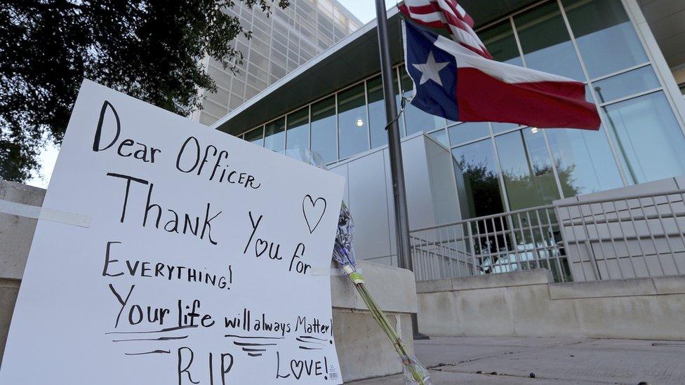 The Texas state flag flies at half staff outside the San Antonio police headquarters