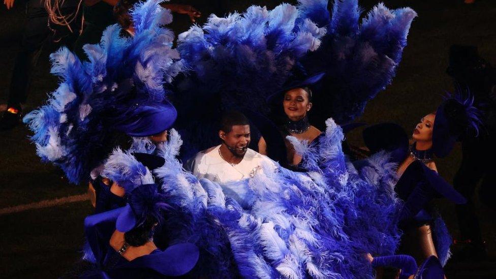 Usher makes an appearance during the Super Bowl half time show