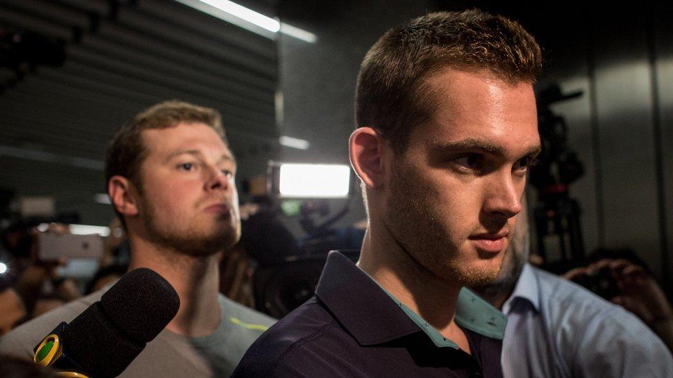 U.S Olympic swimmers Gunnar Bentz and Jack Conger leave the police headquarters at International departures of Rio de Janeiro's Galeo International airport on August 18, 2016 in Rio de Janeiro, Brazil.