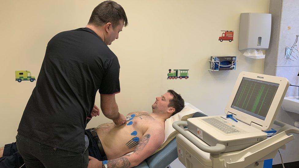 Associate Physiologist Tom Kinrade demonstrating an ECG test on Marc Jubb