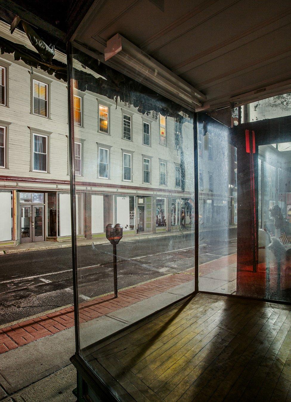 A night view of an empty shop window on an empty street