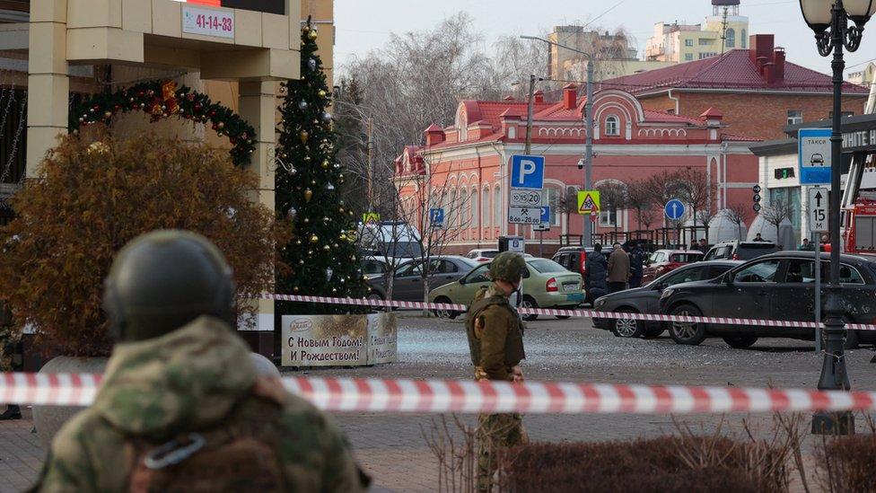 Russian service members secure the area following what Russian authorities say was a Ukrainian military strike in Belgorod, Russia December 30, 2023.