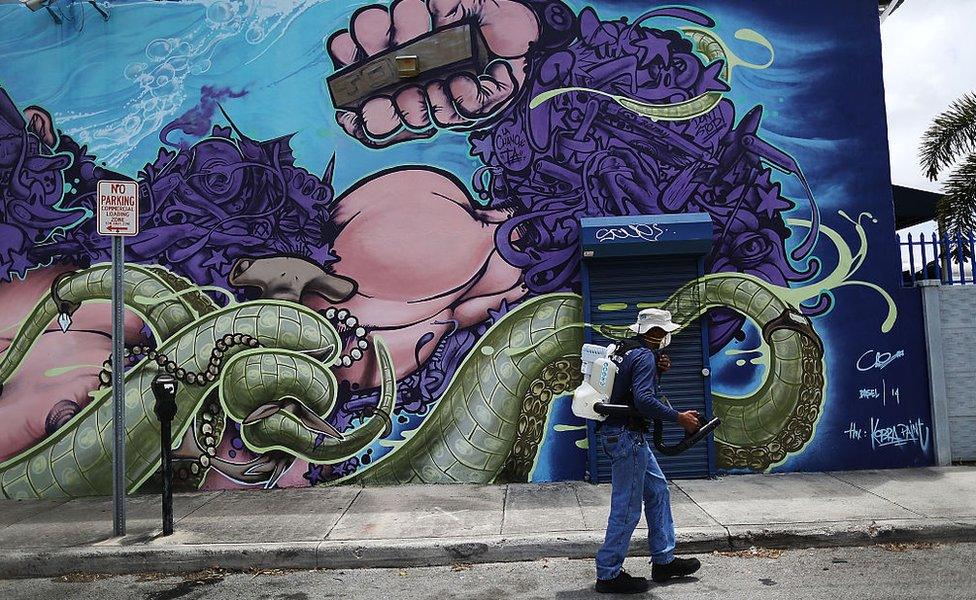 Larry Smart, a Miami-Dade County mosquito control inspector, uses a fogger to spray pesticide to kill mosquitoes in the Wynwood neighbourhood as the county fights to control the Zika virus outbreak