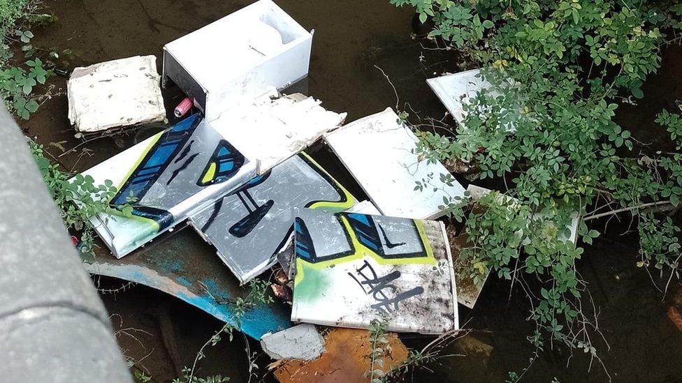 Fridges floating in water under bridge in Grimsby