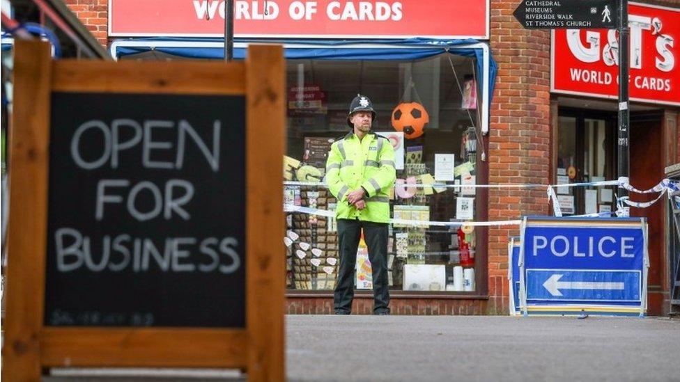 Open for business sign outside closed card shop