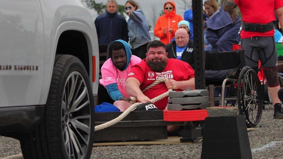 Dave Walsh pulling a car along at an event