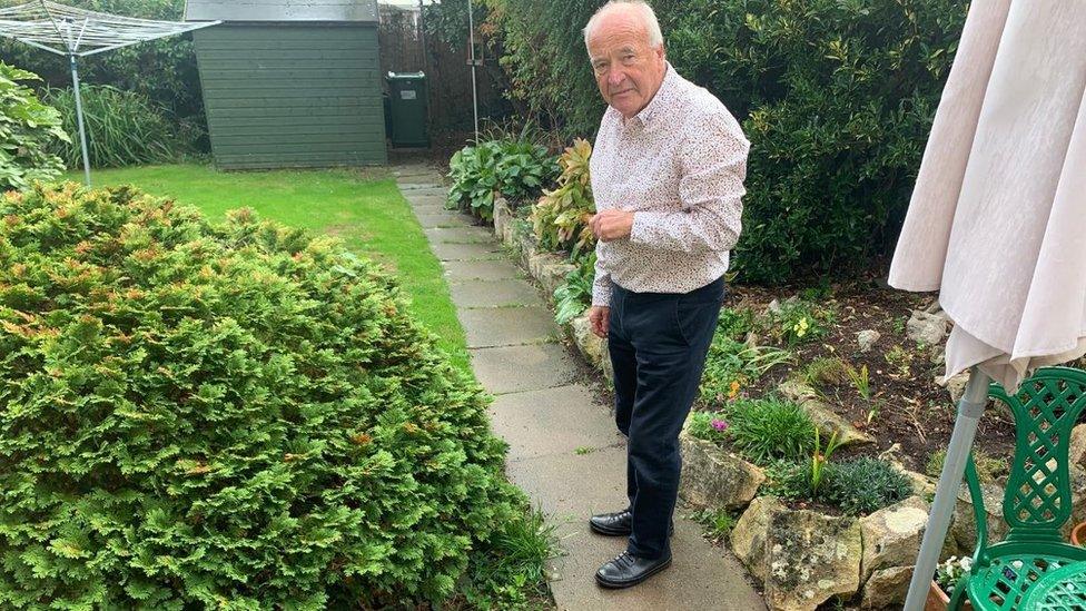 Mr Barber in his garden which floods regularly