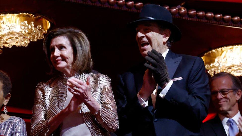 House Speaker Nancy Pelosi and her husband Paul Pelosi, who is wearing a hat and glove following an attack by accused David Wayne DePape in his home in November