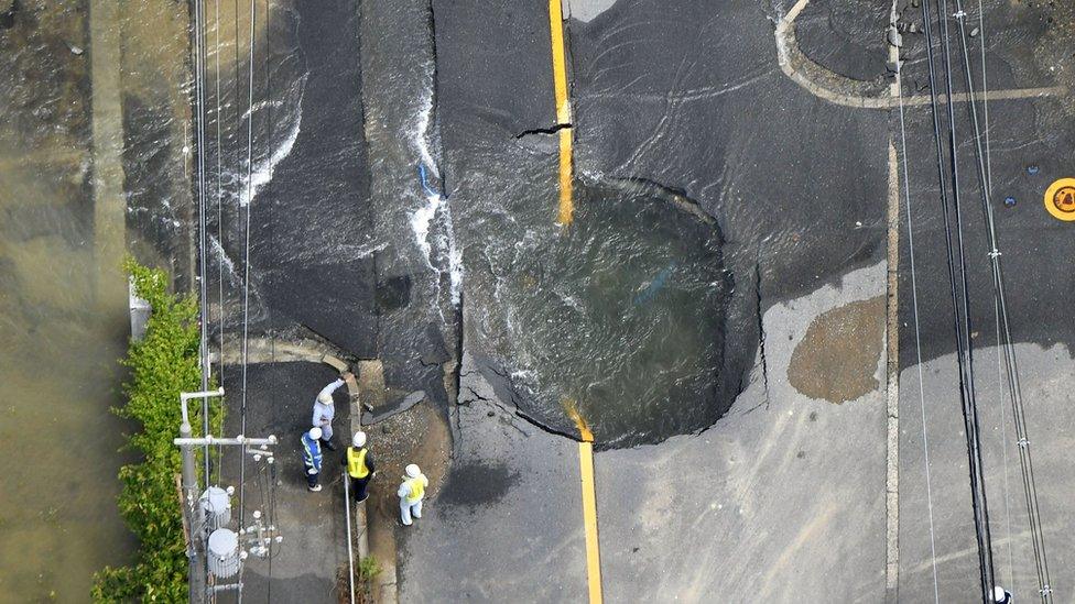 Cracked road flooded with water