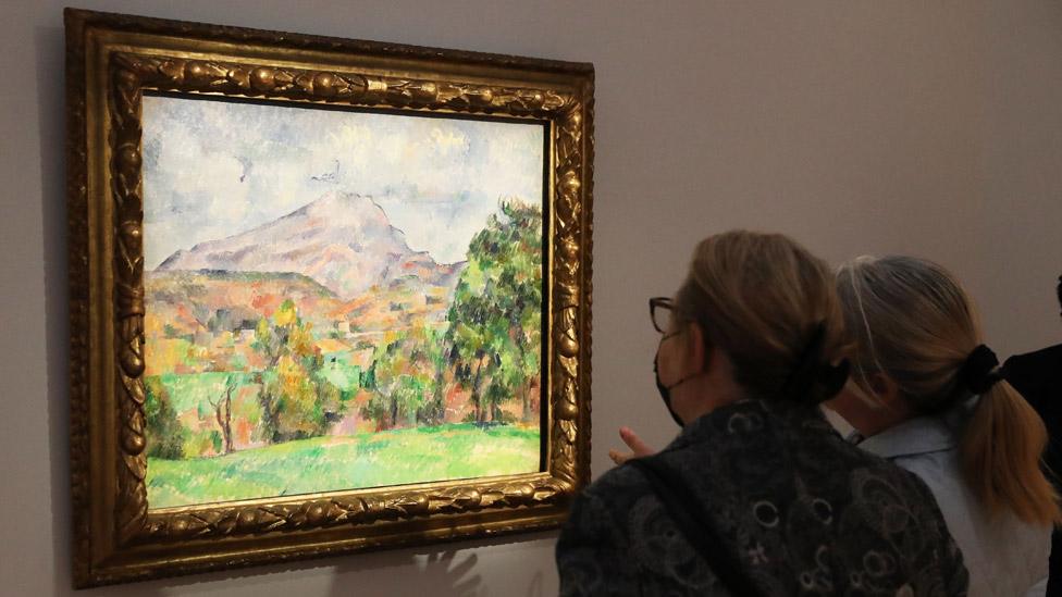 People view La Montagne Sainte-Victoire by French artist Paul Cezanne