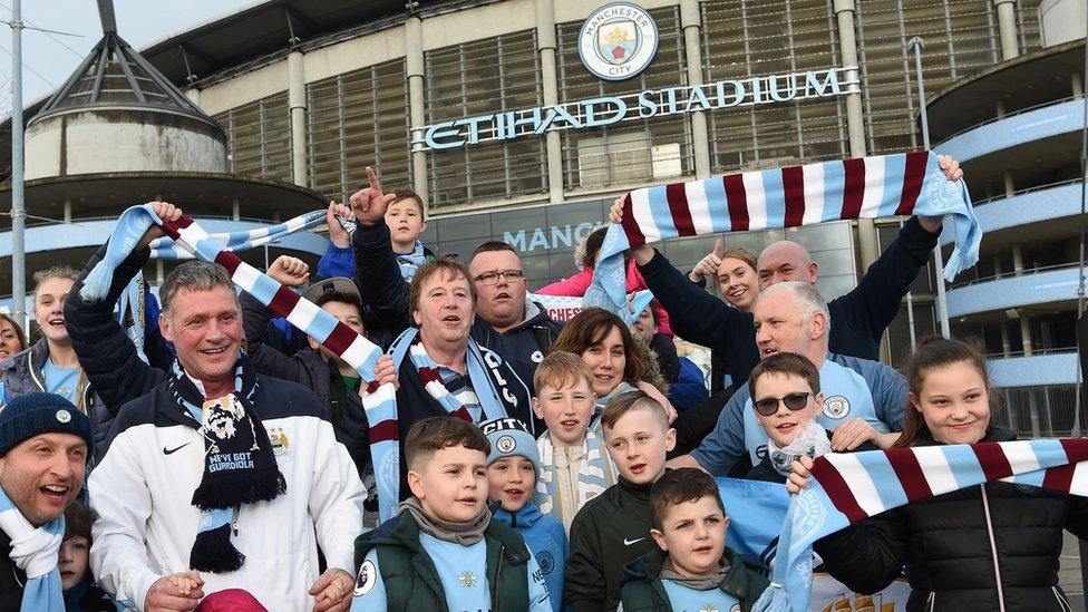 A group of Manchester City fans celebrate