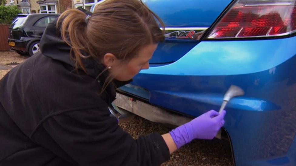 Scene-of-crime officer Katy Stewart looks for clues on a Vauxhall